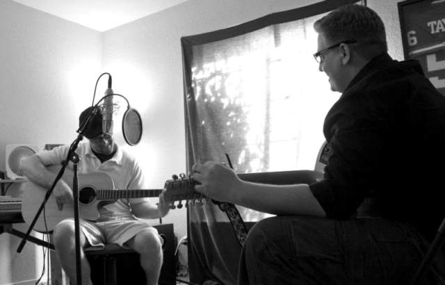 Brandon K. Guttenfelder, co-founder of GuttenBoy Music, playing guitar with a client